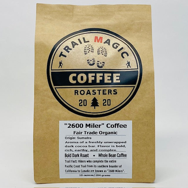 Kraft paper coffee bag with 'Trail Magic Coffee Roasters' branding on a white background
