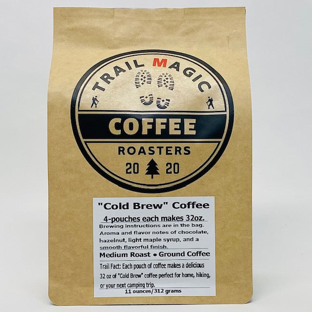 Kraft paper coffee bag with 'Trail Magic Coffee Roasters' logo and product details on a white background