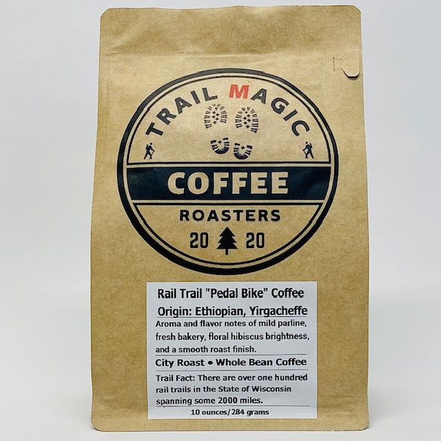 Kraft paper coffee bag with 'Trail Magic Coffee Roasters' branding on a white background