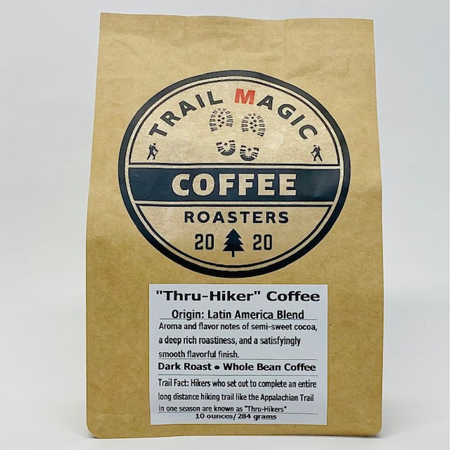 Kraft paper coffee bag with 'Trail Magic Coffee Roasters' branding on a white background