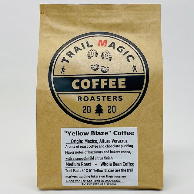 Kraft paper coffee bag with 'Trail Magic Coffee Roasters' branding on a white background