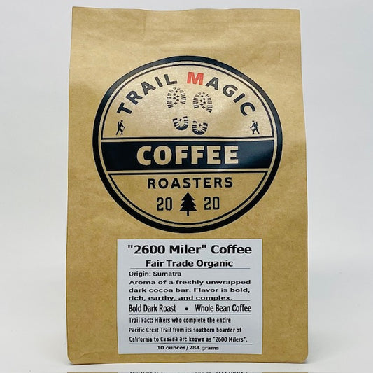 Kraft paper coffee bag with 'Trail Magic Coffee Roasters' branding on a white background