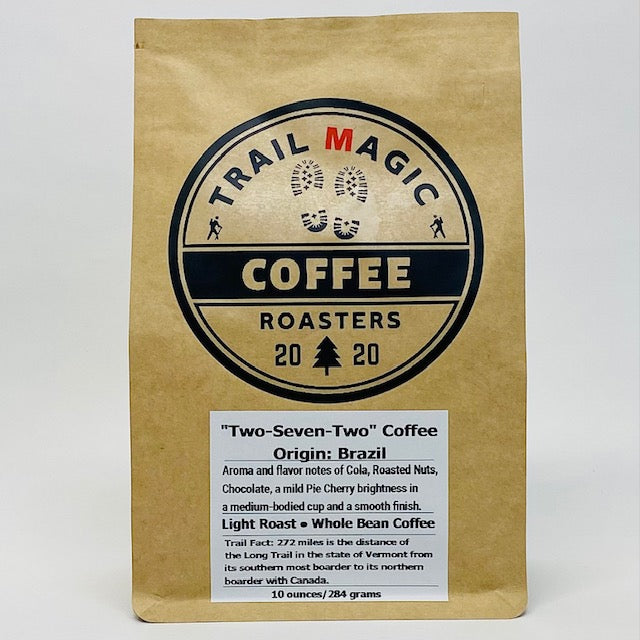 Kraft paper coffee bag with 'Trail Magic Coffee Roasters' logo on a white background